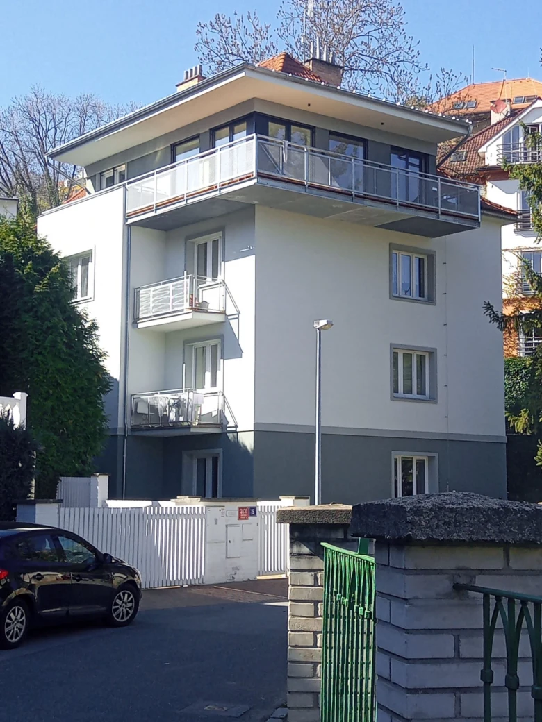 Modernizovaný bytový dům s balkony po revitalizaci fasády.