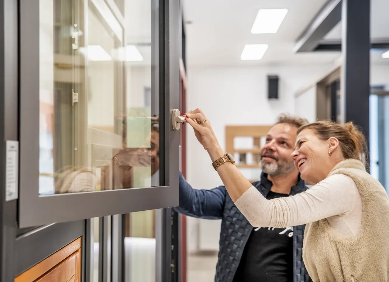 Couple inspecting window handle