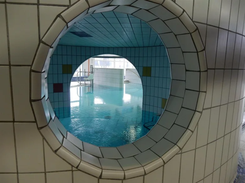Swimming pool view through circular window
