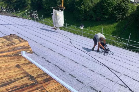 Montáž podkladového materiálu pro šindel na střešní plochu.