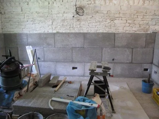 Stavba podkladu domu s betonovými bloky pro obložení soklu.